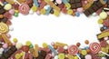 Colorful assorted candies creating a border on a white background, copy space Royalty Free Stock Photo