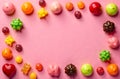 Colorful assorted candy in frame layout on pink background with copy space. Royalty Free Stock Photo