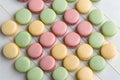 Colorful assorted french macarons arranged diagonally on a tile background Royalty Free Stock Photo