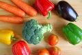 Colorful assorted fresh vegetables scattered on wooden background Royalty Free Stock Photo