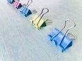 Colorful binder clips on a light blue background Royalty Free Stock Photo