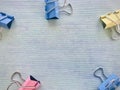 Colorful binder clips on a light blue background Royalty Free Stock Photo