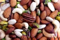 Colorful assorted nuts background - almonds, cashews, pistachios, white almonds texture