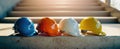 The colorful assortment of safety helmets lined up on stairs.AI generated image Royalty Free Stock Photo