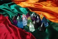 colorful aura crystals lying on crushed velvet