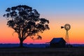 Colorful Australian outback sunset with a windmill.