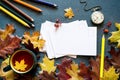 Colorful autumn background with a cup of tea and clean white cards for your text, with bright autumn leaves, pocket watch and colo Royalty Free Stock Photo
