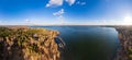 Colorful autumn forest with trees on the shore of a blue lake - top aerial view Royalty Free Stock Photo