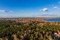 Colorful autumn forest with trees on the shore of a blue lake - top aerial view Royalty Free Stock Photo