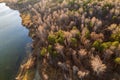 Colorful autumn forest with trees on the shore of a blue lake - top aerial view Royalty Free Stock Photo