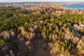 Colorful autumn forest with trees on the shore of a blue lake - top aerial view Royalty Free Stock Photo