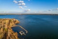 Colorful autumn forest with trees on the shore of a blue lake - top aerial view Royalty Free Stock Photo