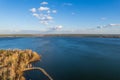 Colorful autumn forest with trees on the shore of a blue lake - top aerial view Royalty Free Stock Photo