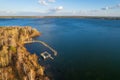 Colorful autumn forest with trees on the shore of a blue lake - top aerial view Royalty Free Stock Photo