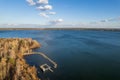 Colorful autumn forest with trees on the shore of a blue lake - top aerial view Royalty Free Stock Photo