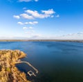 Colorful autumn forest with trees on the shore of a blue lake - top aerial view Royalty Free Stock Photo