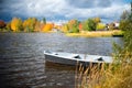 Colorful autumn landscape. Boat on the lake in the autumn forest, rural area in Russia Royalty Free Stock Photo