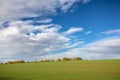 Colorful autumn landscape with fields and trees under blue sky with clouds Royalty Free Stock Photo