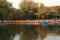 Many boat on the lake in autumn forest.