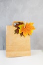 Colorful autumn leaves in a brown craft bag. Sale and shopping concept. Royalty Free Stock Photo