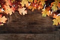 Colorful Autumn Leaves and Lights over Wooden Background Royalty Free Stock Photo