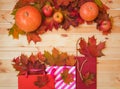 Colorful autumn leaves in paper bags and border made of autumn leaves, pumpkins and apples . Sale and shopping concept Royalty Free Stock Photo