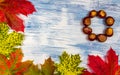 Colorful autumn maple leaves with chestnut to circle on painted white and blue background. Copy space for text or logo Royalty Free Stock Photo