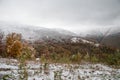 Colorful autumn in the mountains. First snow in october