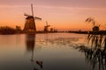 Colorful autumn scene in the famous Kinderdijk canals with windmills. Sunset in Dutch village Kinderdijk, Netherlands, Europe. Royalty Free Stock Photo