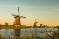 Colorful autumn scene in the famous Kinderdijk canals with windmills. Sunset in Dutch village Kinderdijk, Netherlands, Europe. Royalty Free Stock Photo