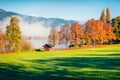 Colorful autumn scene of Kurpark in Thumersbach village, located on the shore of the Zell lake. Great morning view of Austrian