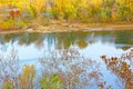 Colorful autumn trees foliage and river waters in the park. Royalty Free Stock Photo