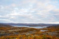 Colorful autumn tundra in front of lake in Liinahamari. Royalty Free Stock Photo