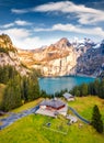 Colorful autumn view from flying drone of unique Oeschinensee Lake.