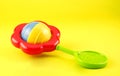 Colorful Baby Rattle on Yellow Background