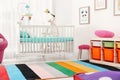 Colorful baby room interior with crib