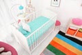 Colorful baby room interior with crib