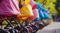 Colorful baby strollers lined up in park, copy space Royalty Free Stock Photo