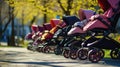 Colorful baby strollers lined up in park, copy space Royalty Free Stock Photo