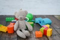 Colorful baby toys, on dark wooden floor in baby room Royalty Free Stock Photo