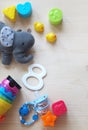 Colorful baby toys and pacifier on a wooden background and copy space Royalty Free Stock Photo