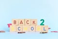 Colorful back to school typography in wooden blocks in blue background.