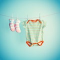 Colorful background for baby girl with two pink socks and body suit with copy space. Royalty Free Stock Photo