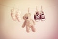 Colorful background for baby girl with two pink socks, sneakers and teddy bear with copy space. Royalty Free Stock Photo