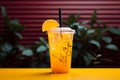 A colorful background complements a zesty lemonade cocktail in a plastic cup Royalty Free Stock Photo