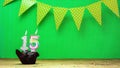 Colorful background happy birthday 15 with decorations festive garlands with muffin on a green background with polka dots Royalty Free Stock Photo