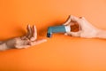 Female hands with inhaler against asthma on color background Royalty Free Stock Photo