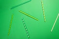 Drinking paper colorful straws for summer cocktails on light green background with copy space. Top view. Royalty Free Stock Photo