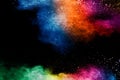 Colorful background of pastel powder explosion.Rainbow color dust splash on black background
