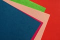 Colorful background of pile of cardboard sheets in different bright solid colors for creative crafts